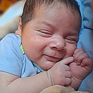 Alonso Fermin is registered to the contest to win money with this photo: baby, blanket, child, closeup, clothing, comfort, cute, face, fingers, hand, indoors, infant, newborn, portrait, resting, skin, sleepy, smile, soft, toddler
