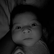 Alonso Fermin is registered to the contest to win money with this photo: baby, infant, face, eyes, hand, clothing, blanket, black_and_white, portrait, close_up, newborn, cute, soft_light, indoors, sleepwear, expression, cozy, child, person, young