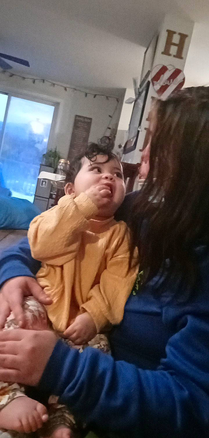 Olivianna is registered to the contest to win money with this photo: abdomen, comfort, conversation, crowd, event, eyewear, flag, fun, fur, gesture, happy, interaction, leisure, mouth, person, room, sitting, sunglasses, t_shirt, thumb