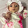 Arabella joined the competition — help win amazing prizes! baby, infant, face, bonnet, pink, bow, floral, onesie, hand, blanket, clothing, portrait, cute, newborn, soft, expression, looking, lying_down, child, person