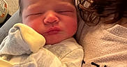 Stephen is registered to the contest to win money with this photo: adult_partial, baby, blanket, bottle, cheeks, closeup, couch, cozy, face, family_moment, hair, indoor, infant, mitten, newborn, onesie, pillow, portrait, sleeping, soft_lighting