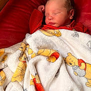 Stephen joined the competition — help win amazing prizes! baby, newborn, infant, sleeping, blanket, winnie_the_pooh, cartoon_blanket, red_clothing, cushion, cozy, soft_texture, portrait, closeup, rosy_cheeks, nap, indoor, plush, peaceful, head, toddler_baby