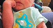 Samuel joined the competition — help win amazing prizes! newborn, baby, sleeping, infant, onesie, pacifier, giraffe, cute, hand, person, indoor, resting, cozy, clothing, child, peaceful, portrait, human, skin, holding