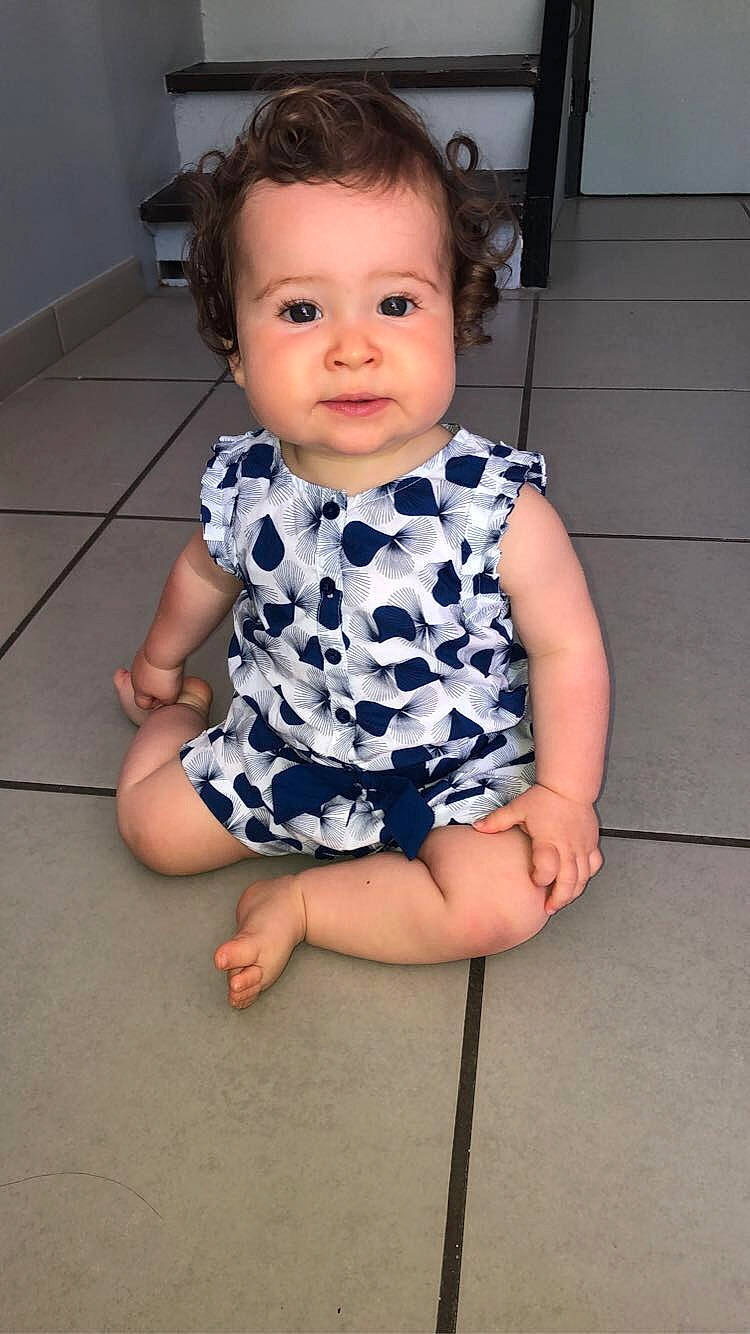 Aïna participe au concours pour gagner de l'argent avec cette photo : baby, baby_toddler_clothing, cheek, child, chin, collar, day_dress, dress, electric_blue, eye, face, flash_photography, head, human_leg, iris, one_piece_garment, pattern, person, skin, sleeve