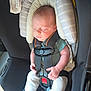 baby, car_seat, sleeping, infant, child, seatbelt, padded_headrest, clothing, sock, pacifier, safety, resting, newborn, transportation, indoor, seat, comfort, cute, peaceful, young