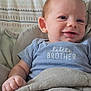 Ryder is registered to the contest to win money with this photo: baby, infant, smile, face, blue_onesie, blanket, hand, pillow, pattern, cozy, child, cute, portrait, resting, indoors, comfort, young, happy, sleepwear, toddler