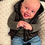 baby, smiling, happy, infant, clothing, jeans, sweater, vest, socks, couch, cushion, soft_texture, indoor, portrait, cute, child, person, seated, face, hands