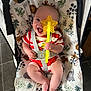 Tobias joined the competition — help win amazing prizes! baby, infant, child, smiling, toy, star_shaped_toy, baby_seat, safety_strap, striped_clothing, happy, cute, indoor, floor_tiles, patterned_seat, legs_crossed, playful, colorful, person, young_child, seat