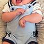 Tobias joined the competition — help win amazing prizes! baby, smiling, infant, blue_romper, white_shirt, cushion, blanket, happy, cute, laughing, child, indoor, soft_texture, skin, legs, arms, head, person, comfort, relaxed