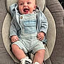 baby, infant, smiling, happy, clothing, romper, jacket, shoes, footwear, baby_seat, cushion, indoor, cute, child, person, portrait, head, face, small_hands, comfort