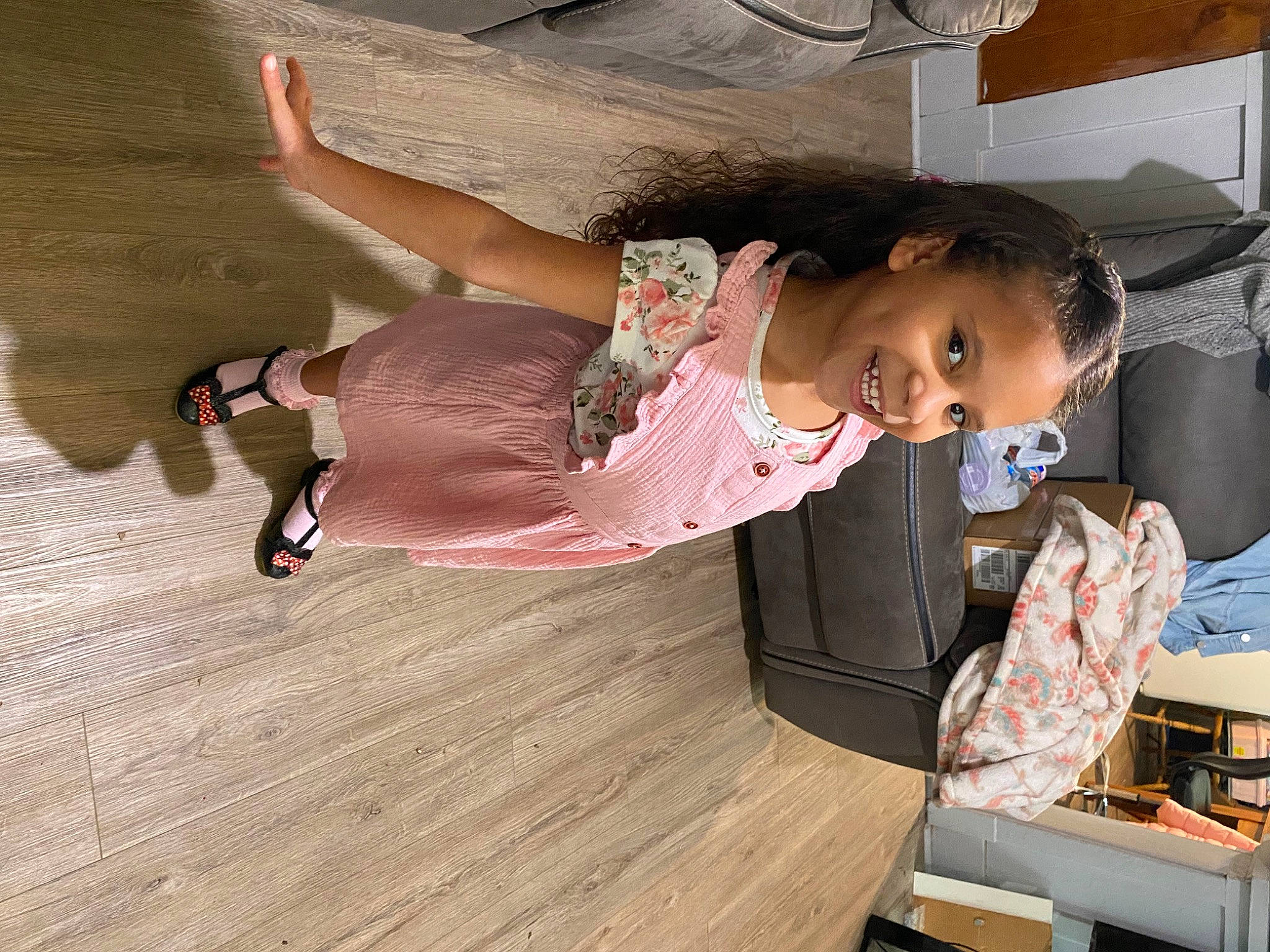 Amiya is registered to the contest to win money with this photo: baby, baby_toddler_clothing, child, comfort, dress, fashion_design, flooring, fun, happy, hardwood, joy, laminate_flooring, person, pink, room, sitting, thigh, toddler, varnish, wood