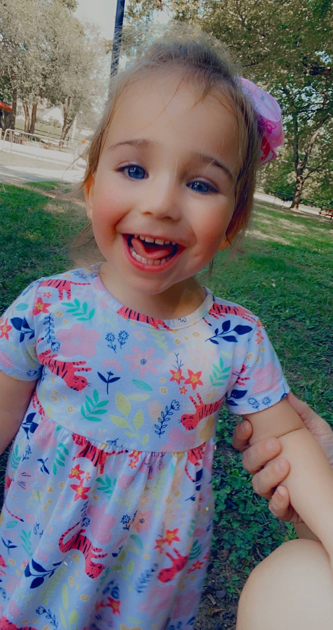 Lyra is registered to the contest to win money with this photo: baby_toddler_clothing, dress, eye, face, facial_expression, grass, hairstyle, happy, head, iris, joy, lip, organ, people_in_nature, person, pink, plant, skin, sleeve, smile