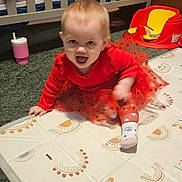 Maebelle joined the competition — help win amazing prizes! baby, carpet, child, crawling, crib, cute, expression, face, floor_mat, happy, indoor, nursery, person, playful, red_dress, smiling, sock, toddler, toy_seat, young_child