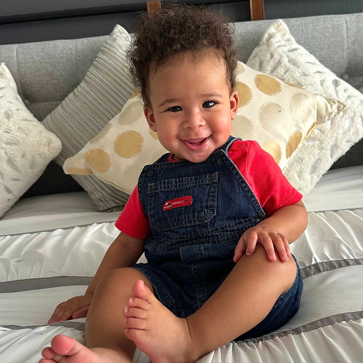 Wave joined the competition — help win amazing prizes! barefoot, bed, child, cozy, curly_hair, cushion, cute, denim_overalls, furniture, happy, home, indoor, person, pillows, portrait, red_shirt, sitting, skin, smiling, toddler