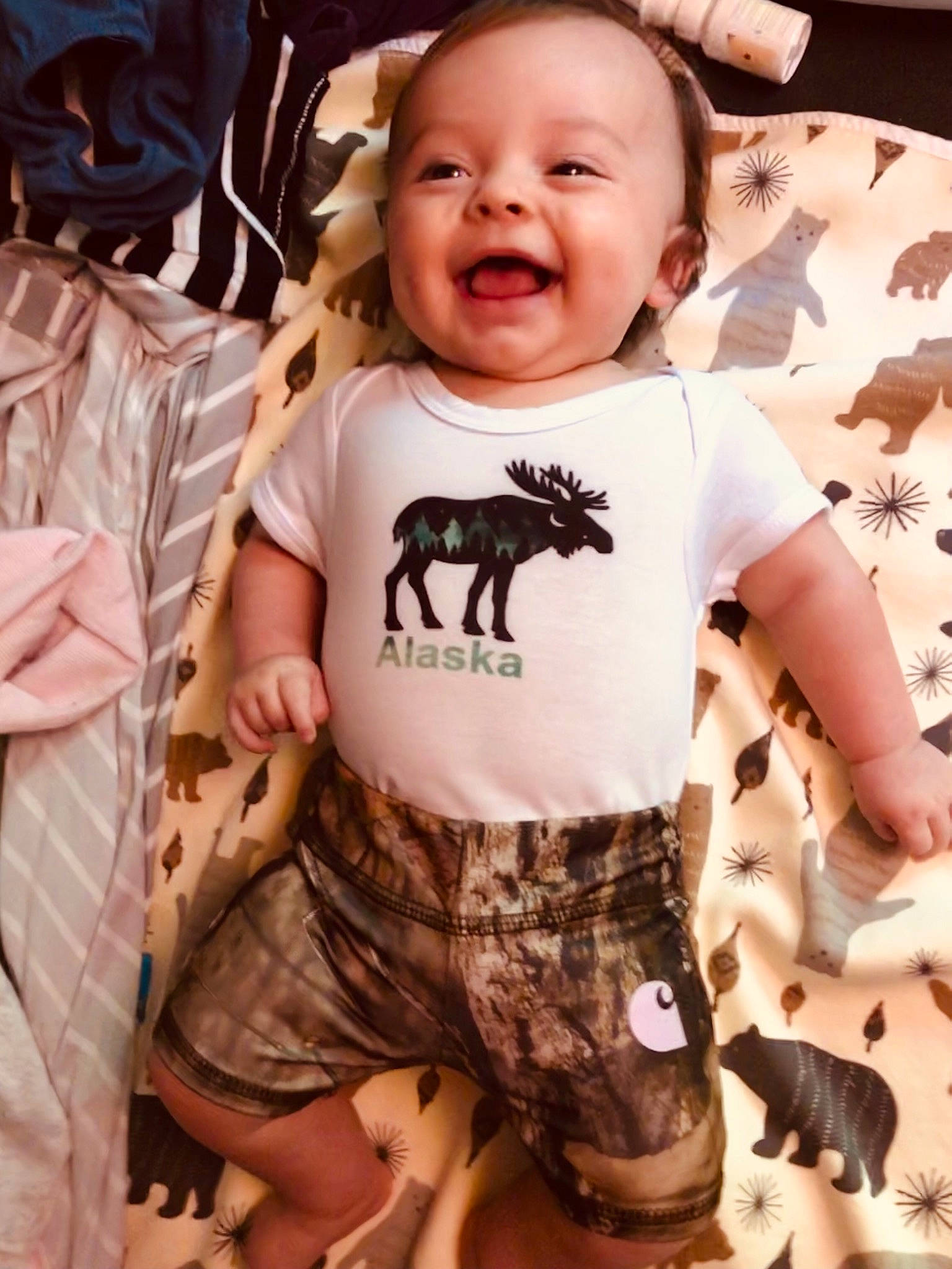 Elouise is registered to the contest to win money with this photo: arm, baby, baby_toddler_clothing, child, cool, eye, facial_expression, finger, gesture, happy, human, neck, people, person, pink, skin, sleeve, smile, t_shirt, toddler