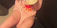 Katherine joined the competition — help win amazing prizes! baby, blanket, bottle, carpet, child, cozy, curious, cute, face, feet, hand, holding, indoor, infant, legs, milk, person, pink_clothing, sitting, soft_lighting