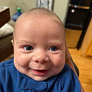 Tyler joined the competition — help win amazing prizes! baby, face, smile, blue_sweater, indoor, close_up, child, person, happy, eyes, cheeks, clothing, elephant_design, skin, head, infant, young_child, portrait, expression, cozy