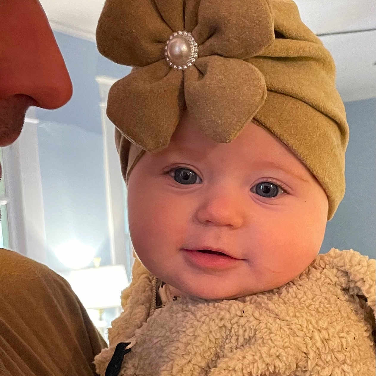 Leighton is registered to the contest to win money with this photo: baby, baby_toddler_clothing, cap, costume_hat, ear, fashion_accessory, happy, hat, head, headgear, headpiece, human_body, lip, neck, nose, organ, skin, sleeve, smile, toddler
