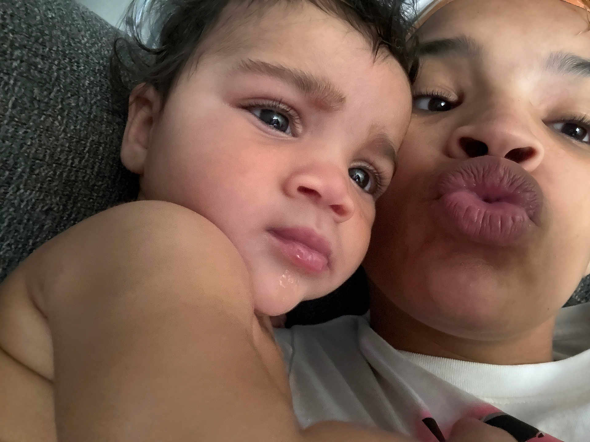 Nyloni is registered to the contest to win money with this photo: child, adult, selfie, close_up, face, skin, expression, couch, indoor, person, affection, funny_face, casual, portrait, human, toddler, emotion, love, hair, eyes