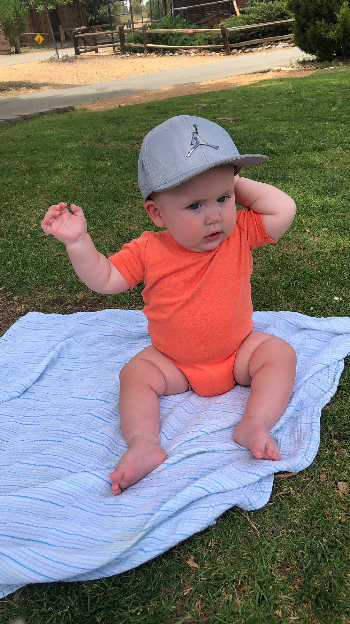 Nixon is registered to the contest to win money with this photo: baby, baby_toddler_clothing, child, grass, hat, headgear, headwear, person, sun_hat, toddler