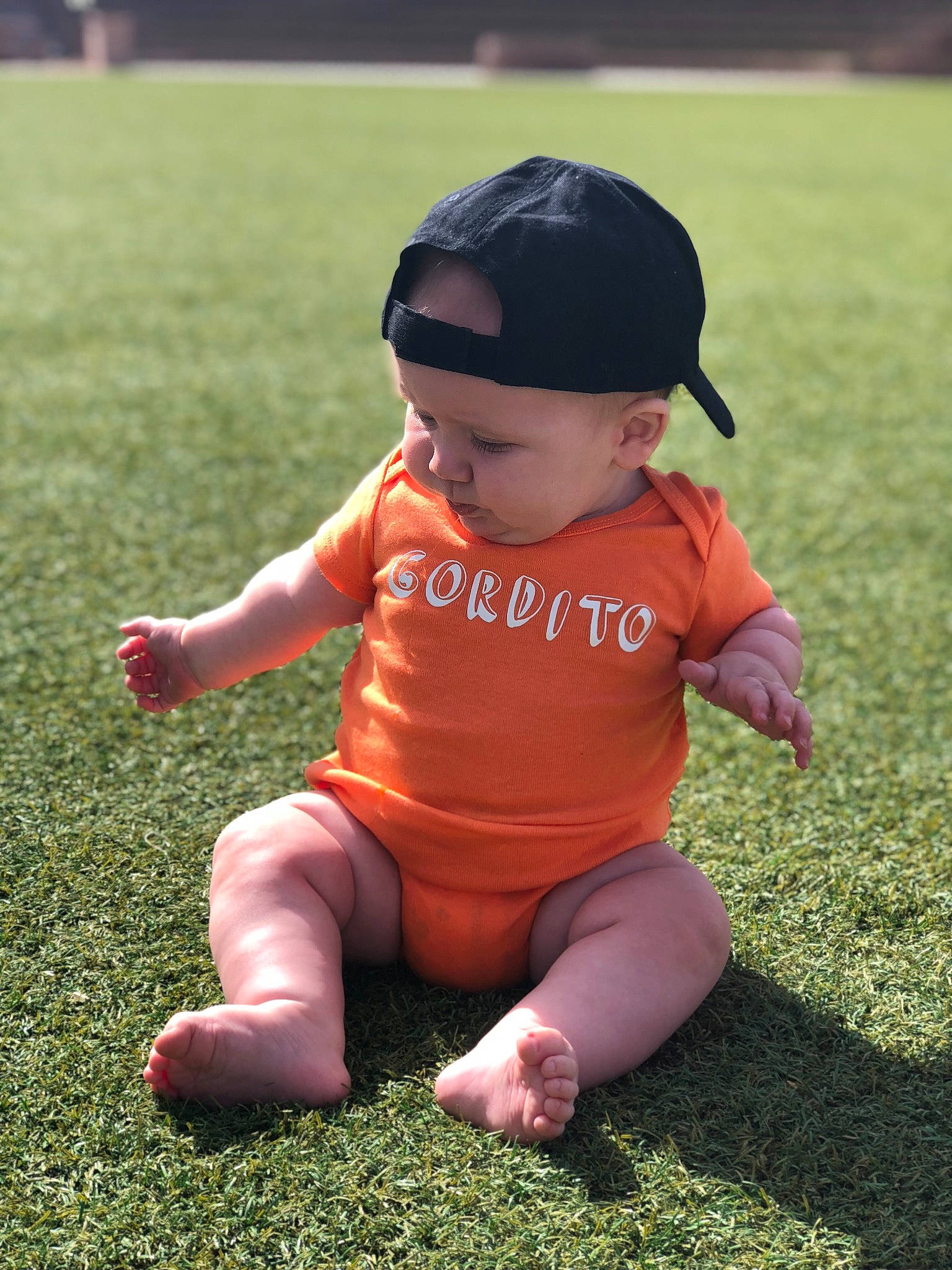 Nixon joined the competition — help win amazing prizes! baby, beauty, child, cool, footwear, fun, grass, grass_family, green, hat, headgear, lawn, leaf, leg, person, pink, play, sitting, skin, summer
