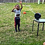 backyard, basketball, bubble_machine, bubbles, casual_clothing, child, daylight, fence, fun, grass, greenery, happy, jumping, outdoor, person, play, smiling, sneakers, table, toy