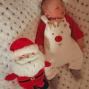 Arthur is registered to the contest to win money with this photo: baby, sleeping, reindeer_outfit, plush_toy, santa_claus, blanket, cozy, holiday, christmas, infant, cute, soft, red_clothing, white, smiling_toy, indoor, child, festive, warm, toy