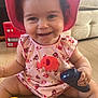 Olivia joined the competition — help win amazing prizes! baby, casual, child, couch, curly_hair, cute, elephant_pattern, floor, happy, home, indoor, onesie, person, pink_hat, playful, remote_control, sitting, smiling, toddler, toy