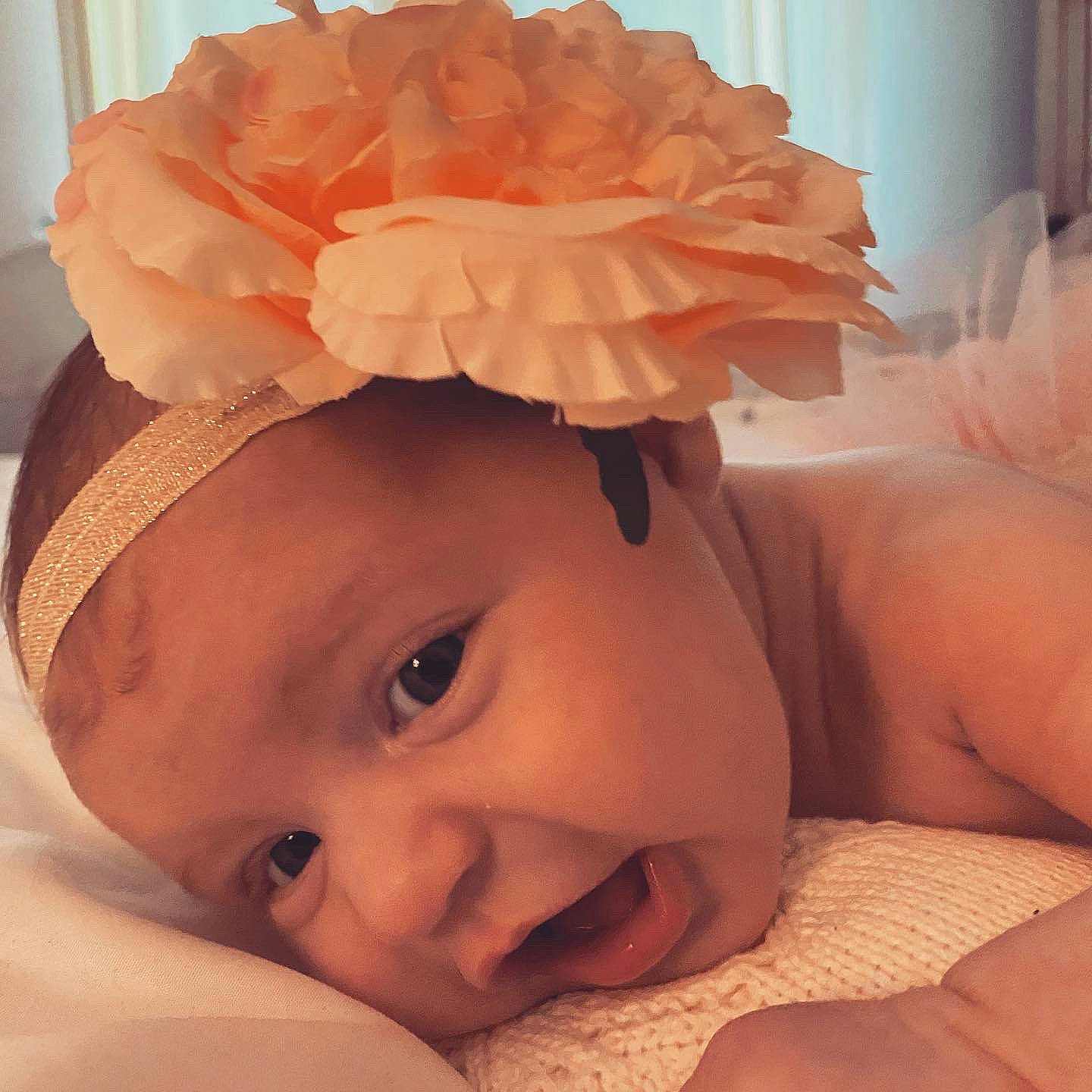 Ava-rose is registered to the contest to win money with this photo: baby, chin, comfort, ear, eyebrow, eyelash, finger, hairstyle, hand, happy, head, headgear, human_body, muscle, person, petal, pink, skin, smile, textile