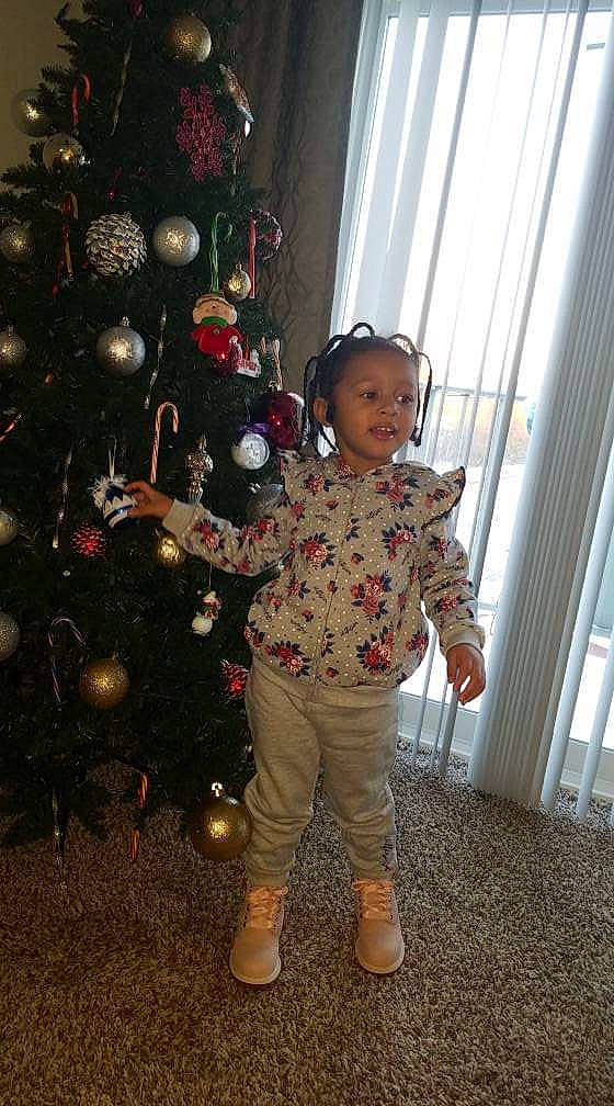 Cheyenne joined the competition — help win amazing prizes! child, christmas, christmas_decoration, christmas_eve, christmas_lights, christmas_ornament, christmas_tree, holiday, holiday_ornament, interior_design, outerwear, person, standing, toddler, tree