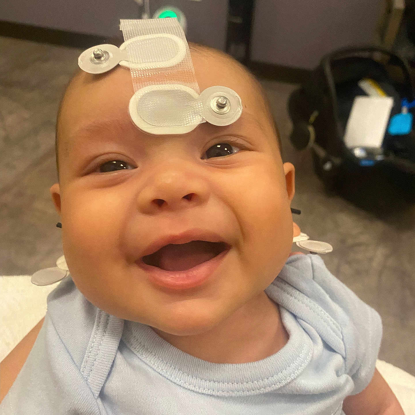 Jasiel joined the competition — help win amazing prizes! baby, baby_boy, baby_girl, blue_shirt, child, closeup, clothing, cute, eyes, face, happy, head, indoor, infant, medical_sensor, mouth, newborn, person, skin, smiling