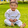 child, toddler, smiling, grass, barefoot, outdoor, park, greenery, clothing, cute, happy, sitting, young, casual_wear, nature, daylight, person, face, playing, park_background