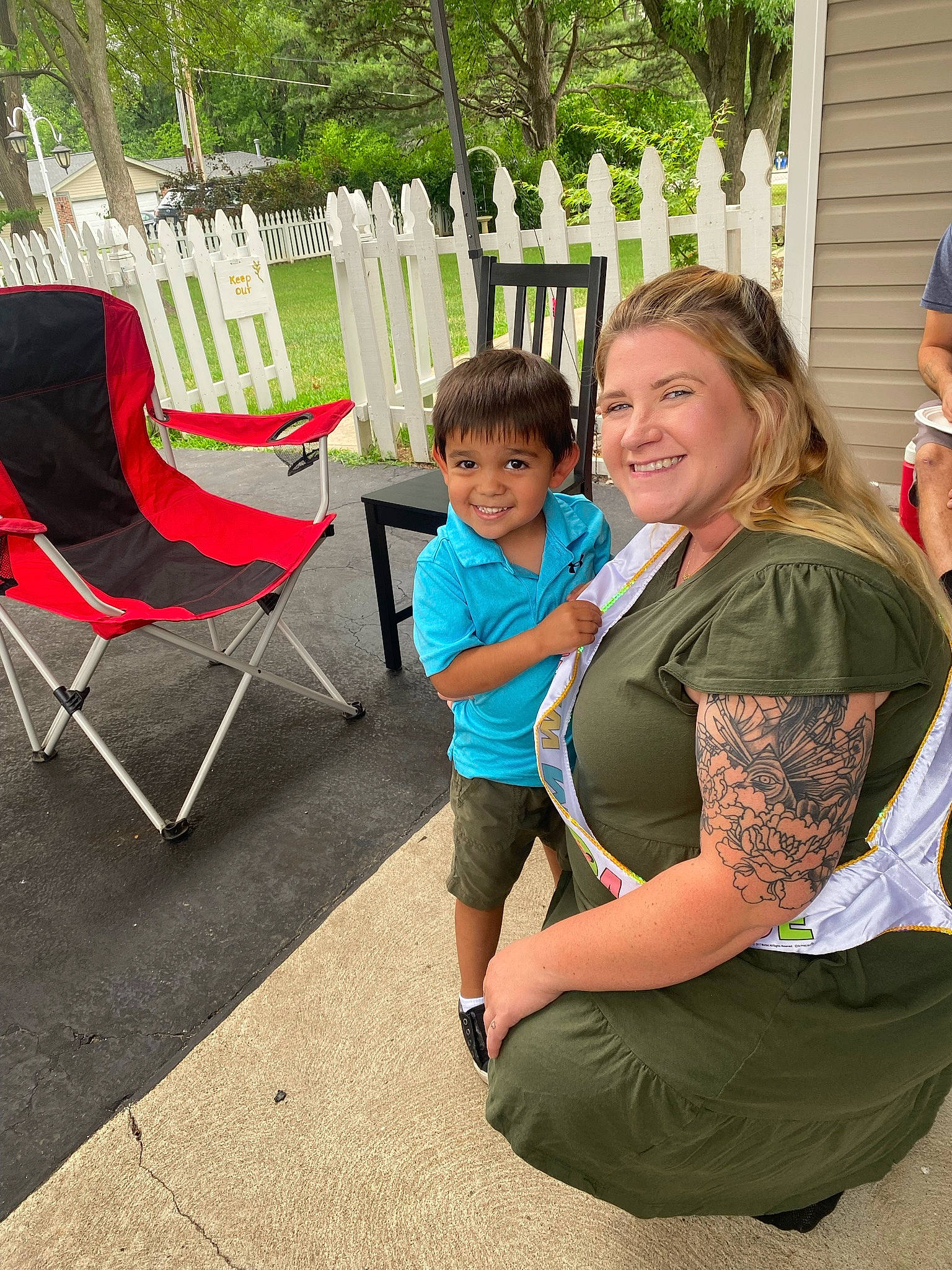 Isaac joined the competition — help win amazing prizes! chair, child, comfort, event, flooring, fun, garden, grass, happy, joy, lap, lawn, leisure, outdoor_furniture, person, plant, recreation, sitting, smile, t_shirt