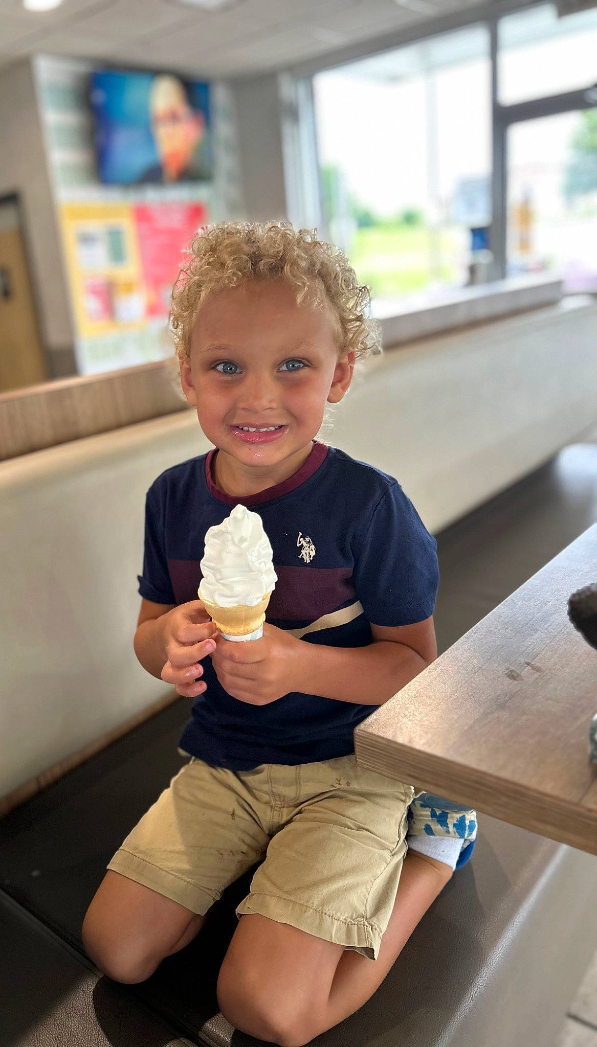 Braven is registered to the contest to win money with this photo: child, dairy, dessert, food, frozen_dessert, fun, gelato, hairstyle, ice_cream, ice_cream_cone, joy, leisure, person, shorts, sitting, smile, sorbetes, t_shirt, table, thumb