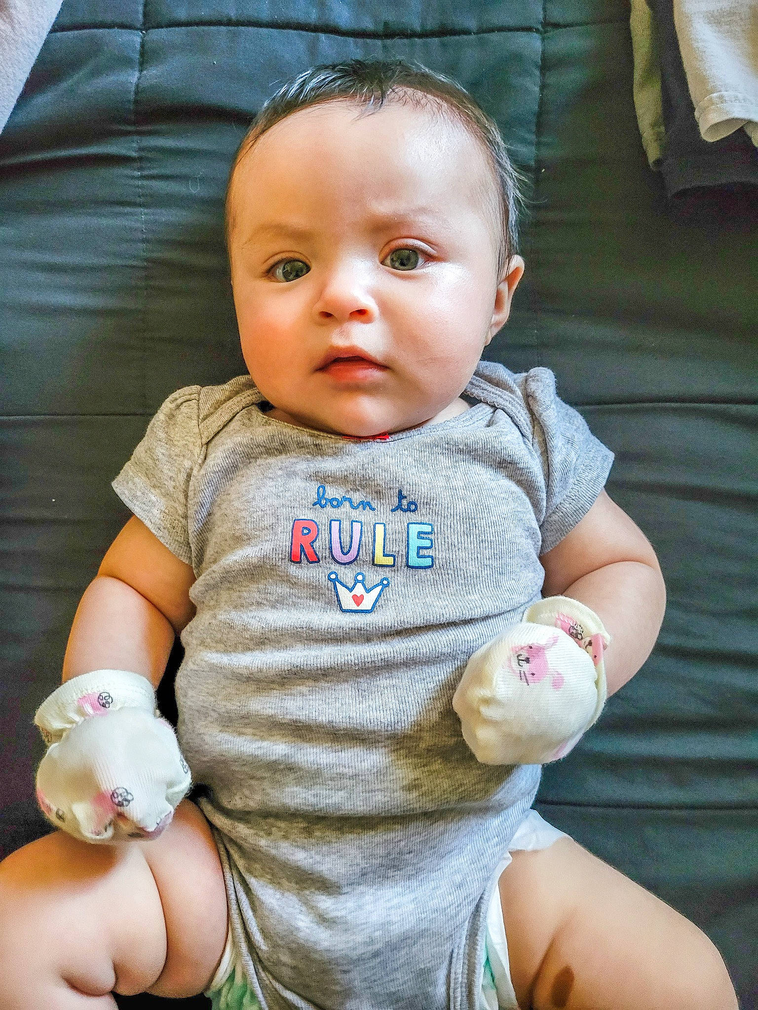 Dahlia is registered to the contest to win money with this photo: arm, baby_toddler_clothing, cheek, chin, eye, face, facial_expression, hairstyle, hand, head, human_body, iris, lip, mouth, nose, organ, person, product, skin, sleeve