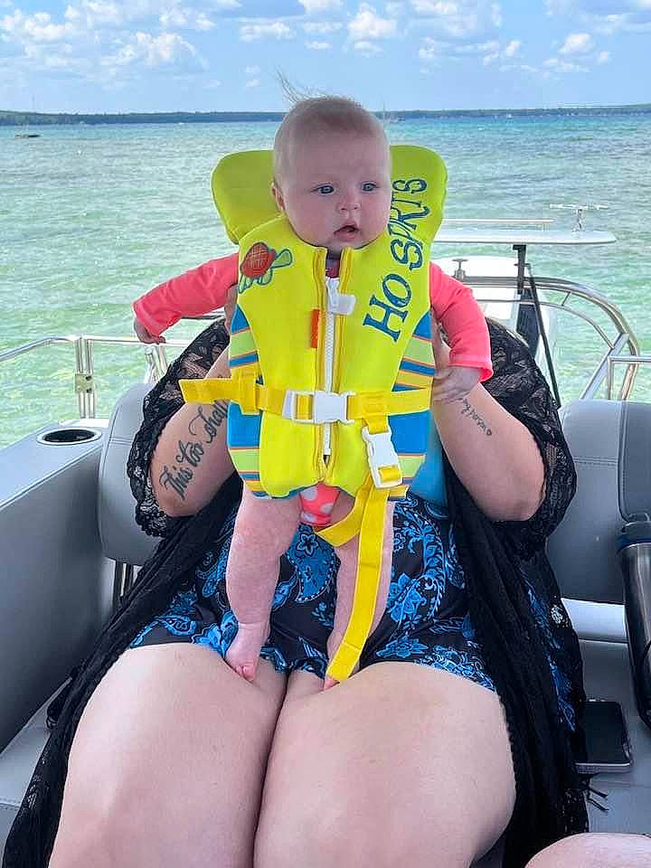 Salem is registered to the contest to win money with this photo: baby_toddler_clothing, blue, boat, boats_and_boating_equipment_and_supplies, cloud, comfort, fun, human_leg, leisure, lifejacket, naval_architecture, outdoor_recreation, person, personal_protective_equipment, recreation, sky, thigh, toddler, travel, water