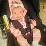 Bethany joined the competition — help win amazing prizes! baby, infant, car_seat, pink_clothing, white_bow, smiling, child, socks, safety_harness, indoors, cute, happy, seat_belt, headwear, car_seat_warning_label, person, toddler, car_seat_padding, child_safety, closeup