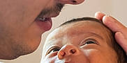 Gabriel participe au concours pour gagner de l'argent avec cette photo : baby, infant, man, glasses, face, close_up, smile, affection, love, parent, child, skin, head, hand, person, portrait, indoor, gentle, emotion, bond