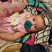 Everly is registered to the contest to win money with this photo: baby, blanket, bodypart, bonnet, cap, clothing, couch, daisy, face, finger, flower, flowerarrangement, furniture, hand, hat, head, person, photography, plant, portrait
