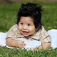 Ezekiel is registered to the contest to win money with this photo: baby, smiling, grass, blanket, shirt, child, happy, face, outdoor, infant, portrait, cute, toddler, nature, young, lying_down, fun, skin, person, casual_clothing