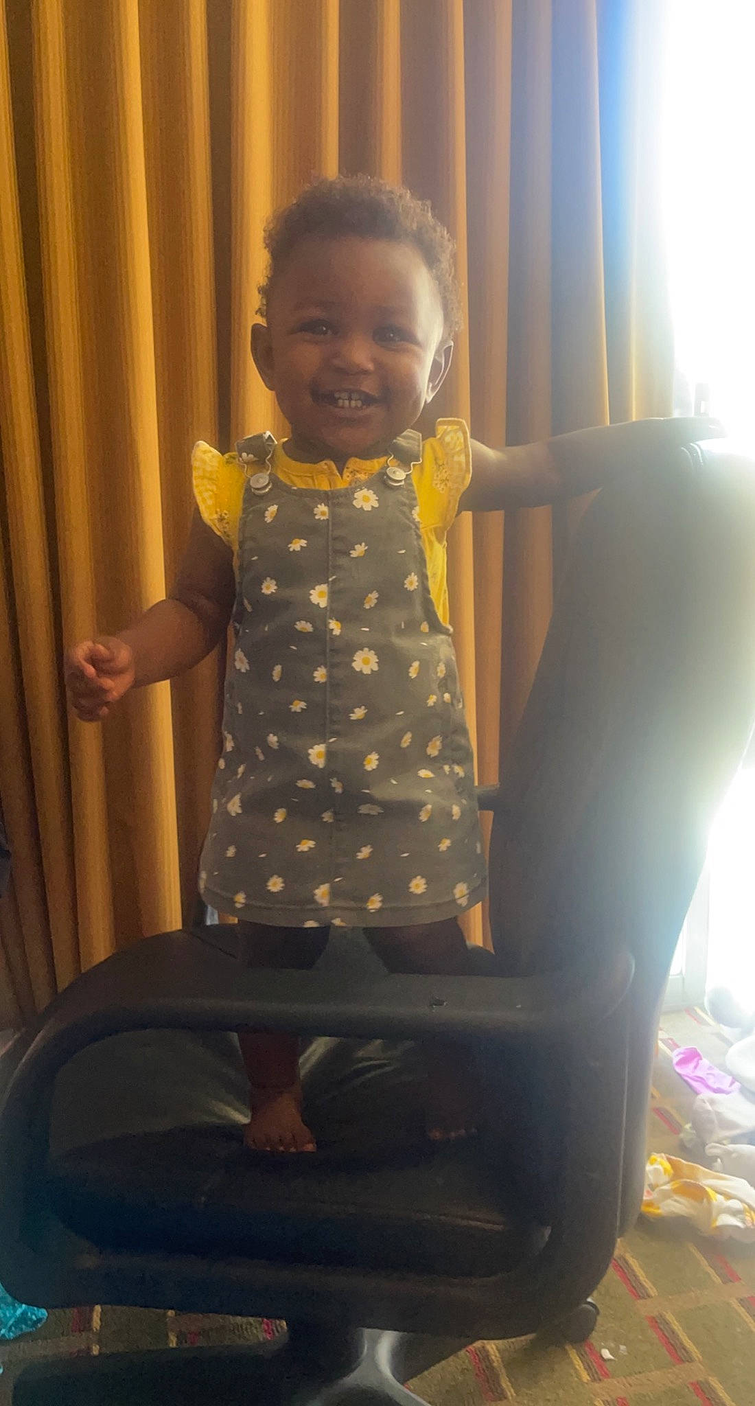 Ta'Miya is registered to the contest to win money with this photo: arm, baby_toddler_clothing, child, comfort, curtain, elbow, finger, fun, gesture, happy, joint, joy, leg, muscle, person, shoulder, smile, standing, thigh, thumb