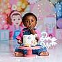 baby, cake, birthday, party, balloons, decorations, child, smiling, pink, blue, pastel_colors, overalls, floor, celebration, colorful, cute, frosting, happy, sitting, one_year_old