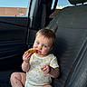 baby, child, car_seat, interior, blue_eyes, food, crumbs, clothing, onesie, window, sky, cloud, seatbelt, car, person, sitting, cute, infant, hand, foot