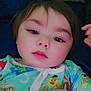 Randy is registered to the contest to win money with this photo: baby, blanket, cartoon_characters, child, close_up, comfort, cozy, cute, expression, face, head, indoors, lying_down, pajamas, person, portrait, resting, sleepwear, soft_lighting, young_child