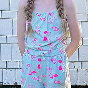 Graci joined the competition — help win amazing prizes! background, braids, casual_clothing, child, daylight, floral_pattern, girl, grass, happy, nature, outdoor, person, portrait, romper, smile, standing, summer, sunlight, white_wall, young