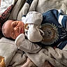 Noah is registered to the contest to win money with this photo: newborn, baby, sleeping, infant, portrait, blanket, clothing, knitwear, mittens, hat, plush_toy, stuffed_animal, bed, bedding, cozy, indoors, peaceful, cute, resting, photography