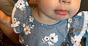 Cecilia joined the competition — help win amazing prizes! baby, child, face, blue_dress, floral_pattern, red_bow, tongue_out, cute, person, holding, hand, headband, earring, indoor, adult, skin, expression, portrait, close_up, happy