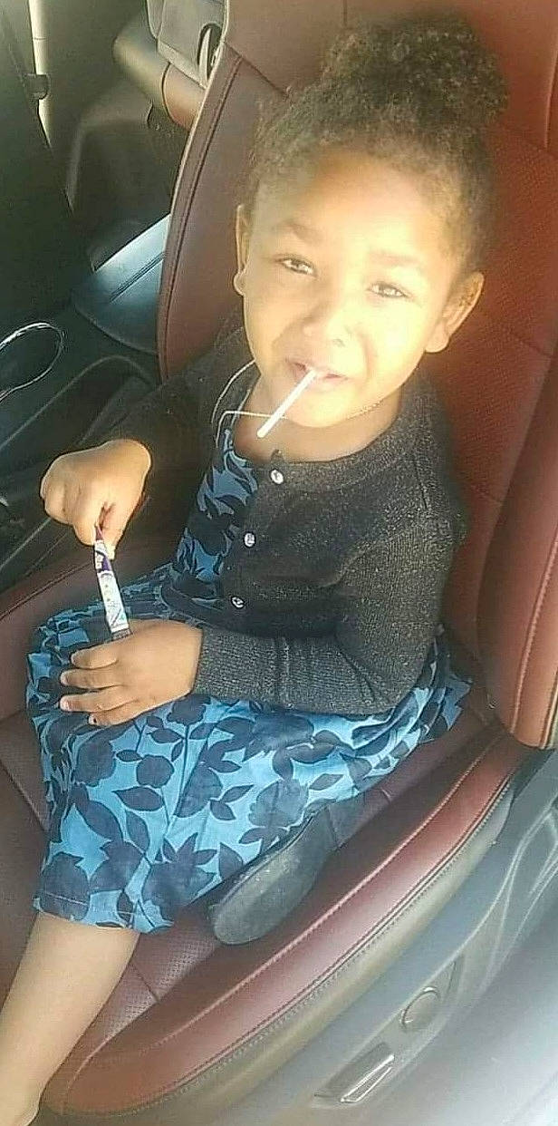 Paris is registered to the contest to win money with this photo: arm, black_hair, car, car_seat, cool, dress, face, finger, hair, hairstyle, hand, human, joy, leg, mouth, neck, organ, person, seat_belt, thigh