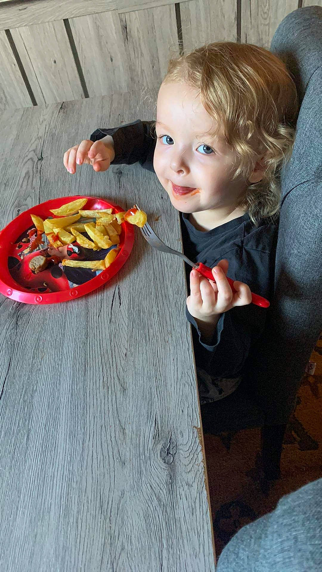 Nohlana participe au concours pour gagner de l'argent avec cette photo : automotive_wheel_system, baby, baby_toddler_clothing, chair, child, circle, eye, flooring, fun, hand, person, plate, play, room, sitting, suit, table, tableware, toddler, toy