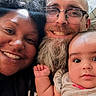 baby, smiling, couple, selfie, glasses, beard, afro, crocheted_blanket, indoor, happy, portrait, family, closeup, casual_clothing, infant, skin, head, hand, person, toddler